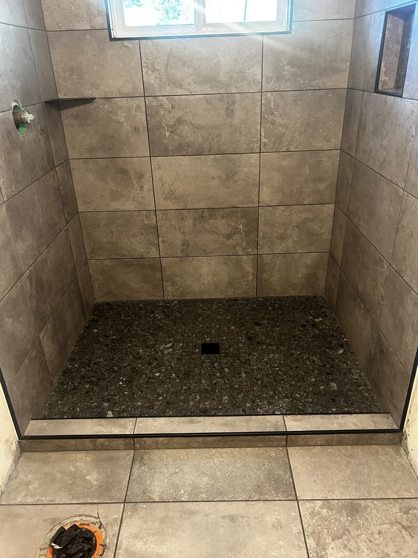 Modern bathroom with patterned floor tiles and clean fixtures